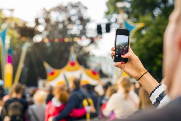 Woman photographing festival with smart phone